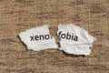 Torn paper written xenofobia, portuguese and spanish word for xe Royalty Free Stock Photo