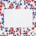 Torn piece of white notepad paper with lines on red, white and blue stars paper background Royalty Free Stock Photo