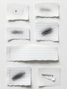 Torn pieces of paper with pencil smudges and the word \'memory\' isolated on white background Royalty Free Stock Photo