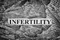 Torn pieces of paper with the word Infertility Royalty Free Stock Photo