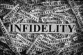 Torn pieces of paper with the word Infidelity Royalty Free Stock Photo