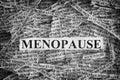 Torn pieces of paper with the word Menopause