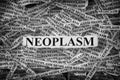 Torn pieces of paper with the word Neoplasm