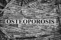 Torn pieces of paper with word Osteoporosis