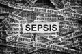 Torn pieces of paper with the word Sepsis