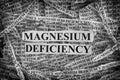 Torn pieces of paper with words Magnesium Deficiency