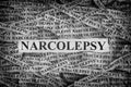 Torn pieces of paper with the words Narcolepsy