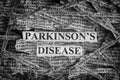 Torn pieces of paper with the words Parkinson`s disease
