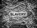 Torn pieces of paper with the words Slavery Royalty Free Stock Photo