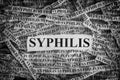 Torn pieces of paper with the words Syphilis