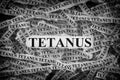 Torn pieces of paper with the words Tetanus