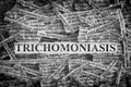 Torn pieces of paper with the words Trichomoniasis