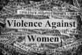 Torn pieces of paper with the words Violence Against Women