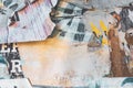 Torn ragged poster paper layers on the wall as grunge background Royalty Free Stock Photo