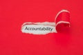 Torn red paper revealing the word of accountability concept