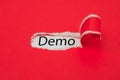 Torn red paper revealing the word Demo. Business concept Royalty Free Stock Photo