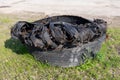 A torn tire from a truck. Old tires left on the side of the road