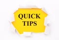 Torn white paper lies on a bright yellow background with the text QUICK TIPS