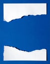 Torn White Paper Strips on Blue Background Royalty Free Stock Photo