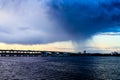 A tornado crossing a bridge over a body of water Royalty Free Stock Photo