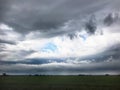 Storm clouds over field farm landscape