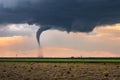 Tornado spins beneath a supercell thunderstorm Royalty Free Stock Photo