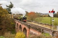 Train steams over the viaduct Royalty Free Stock Photo