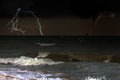 A tornado taring across a deserted beach on ocean Royalty Free Stock Photo