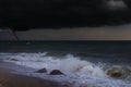 A tornado taring across a deserted beach on ocean Royalty Free Stock Photo