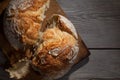 Torned homemade bread loaf on old cutting board with a free space on the right