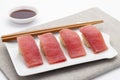 Toro nigiri sushi or fatty tuna nigirizushi served on rectangle white plate