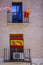 Facade of a house, with numerous flags of Spain