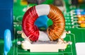 Toroidal transformer coil. Colorful wire winding on inductor with ferrite core Royalty Free Stock Photo