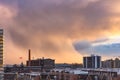 Storm clouds above the Toronto Carpet Factory and Lake Ontario getting hit with colorful sunset light Royalty Free Stock Photo