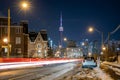 Car light trails in West Queen West leading towards the Toronto skyline and CN Tower - Winter snow