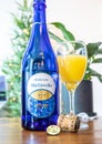 Mimosa next to a bottle of Blu Giovello Prosecco, brightly lit modern room