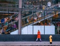 TORONTO, CANADA - 01 04 2020: A girl walking along the University avenue in front of glass wall of the Four Seasons