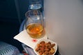 TORONTO, CANADA - JAN 28th, 2017: Air Canada Business class in a passenger plane. A glass of whisky and some warm nuts Royalty Free Stock Photo