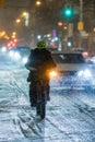 Food delivery driver on a bike during a snow storm on Queen Street West in Toronto