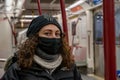 TORONTO, CANADA - JANUARY 23, 2021: LATINA WOMAN WEARING MASK ON TTC DURING COVID-19 PANDEMIC.