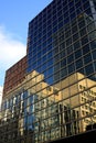 TORONTO, CANADA - JANUARY 8. 2012: Skyscrapers and cloudless blue sky reflecting in glass facade Royalty Free Stock Photo