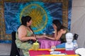 TORONTO, ON, CANADA - JULY 29, 2018: A fortune teller with a client at Kensington market in Toronto.