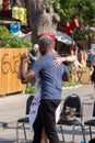 TORONTO, ON, CANADA - JULY 29, 2018: An interracial couple dancing in the street at Kensington market in Toronto.