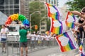 Gay Pride Parade spectators holding gay rainbow flags during Toronto Pride Parade in 2017