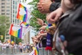 Gay Pride Parade spectators holding gay rainbow flags during Toronto Pride Parade in 2017