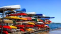 Many colorful Kayaks stacked on the racks at Toronto harbor front center