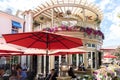 Busy al fresco restaurant with people sitting outside and eating or drinking and enjoying sunny day Royalty Free Stock Photo