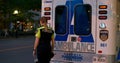 Toronto, Canada - May 6, 2023: Paramedic opens ambulance door goes outside. Young woman paramedic smiles looks at camera