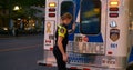 Toronto, Canada - May 6, 2023: Paramedic opens ambulance door goes outside. Young woman paramedic smiles looks at camera