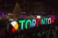 TORONTO, CANADA 12 23 2018: Night view on Nathan Phillips square in the major Canadian city Toronto with people having fun on the